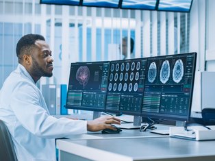 Medical Professional Analyzing Brain Scans on Monitors in a Modern Laboratory